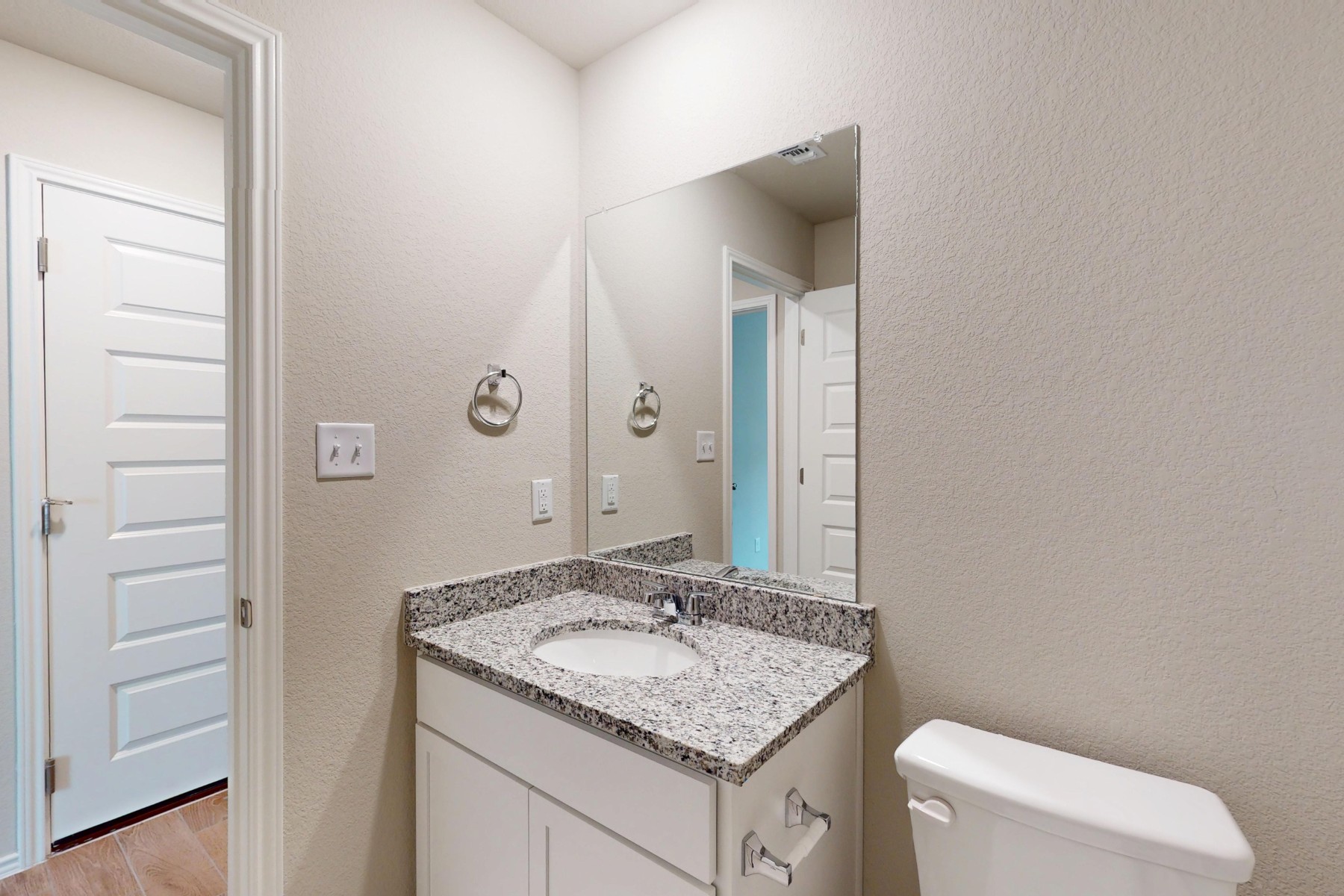 20009 Hirono Drive Manor, TX 78653 - Photo 29 of 39 a bathroom with a granite countertop sink and a toilet