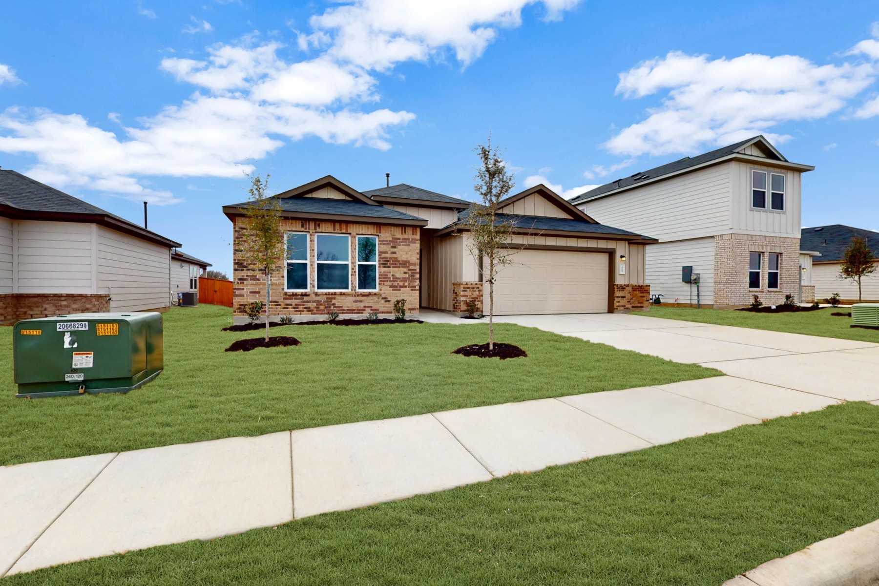 20009 Hirono Drive Manor, TX 78653 - Photo 38 of 39 a front view of a house with a garden and yard