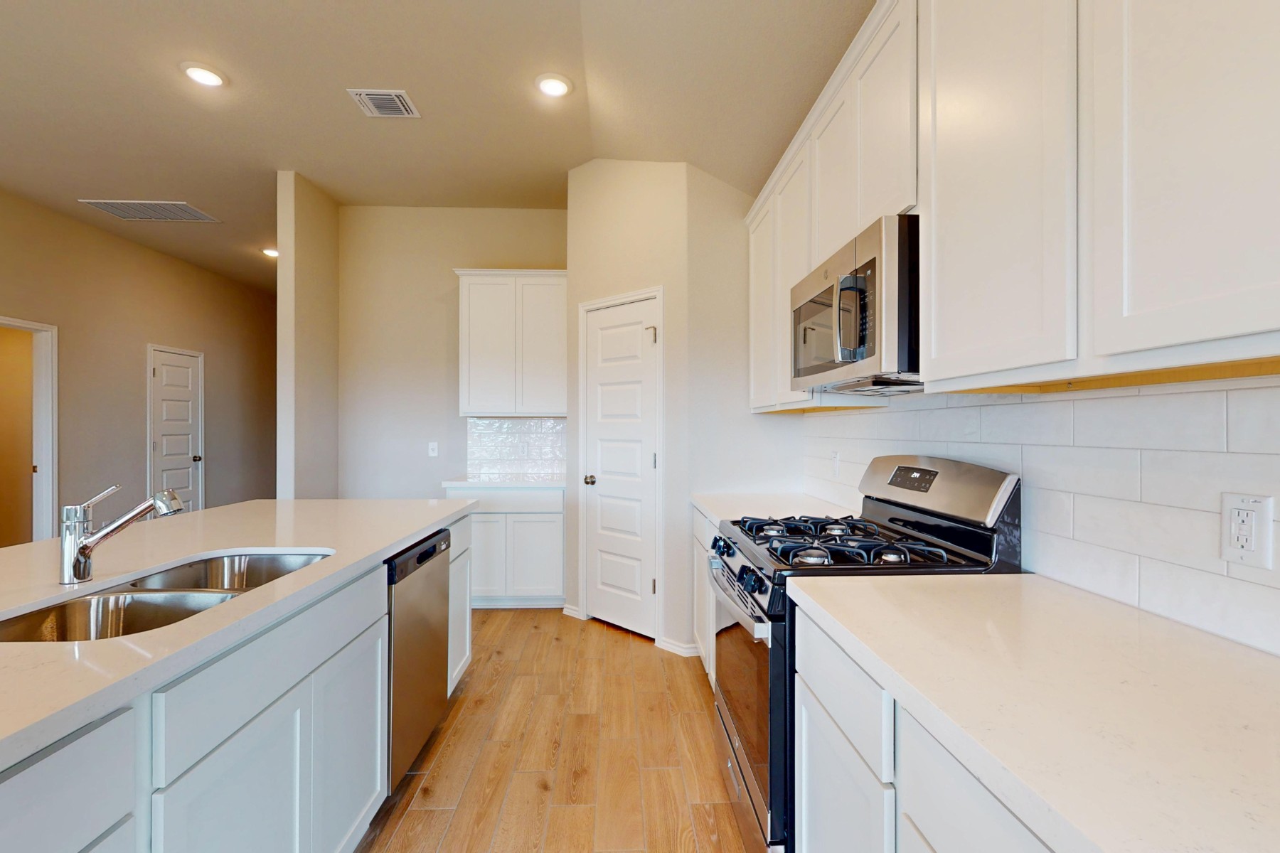 20009 Hirono Drive Manor, TX 78653 - Photo 6 of 39 a kitchen that has a sink and a stove
