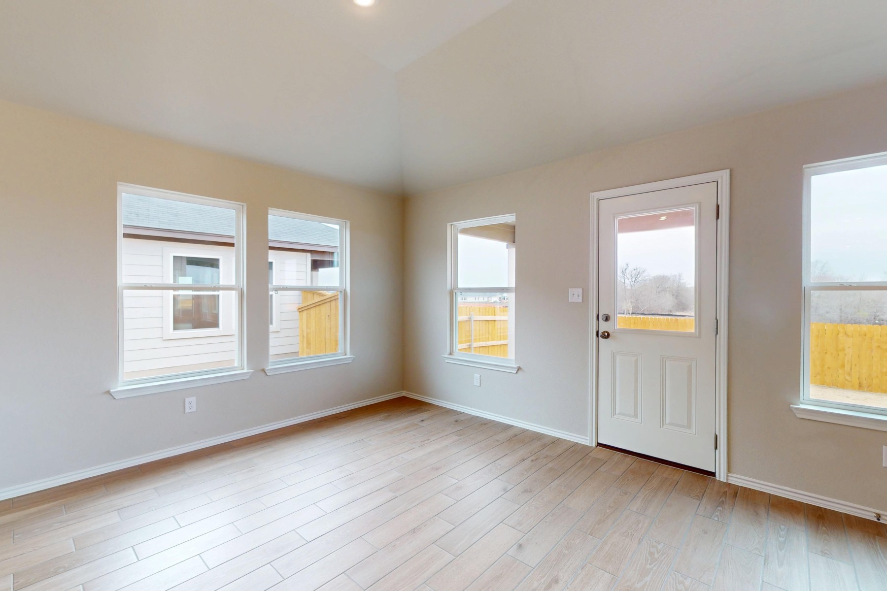 20009 Hirono Drive Manor, TX 78653 - Photo 8 of 39 a view of an empty room with wooden floor and a window