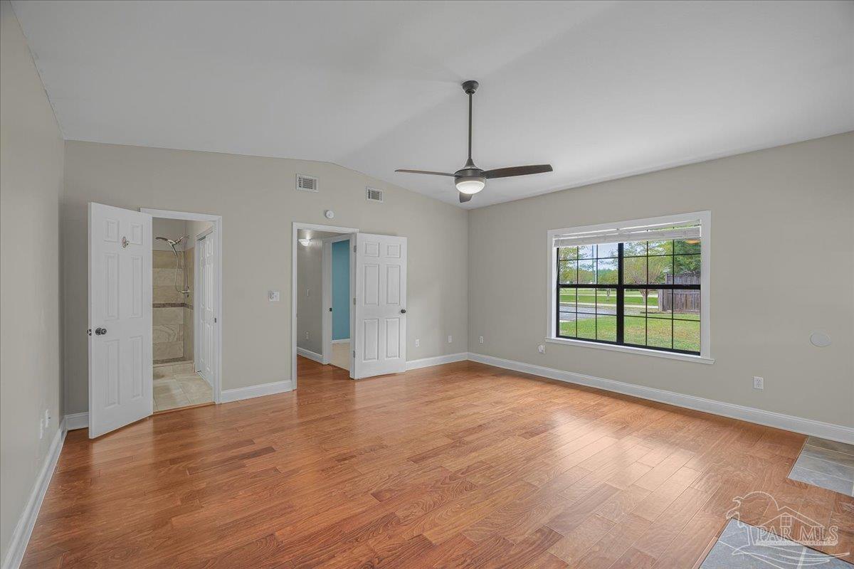 5946 Greenfield Street Pace, FL 32571 - Photo 11 of 42 a view of an empty room with window and wooden floor
