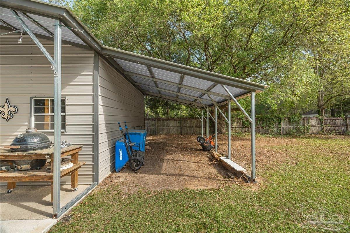 5946 Greenfield Street Pace, FL 32571 - Photo 12 of 42 a view of a patio with a table and chairs