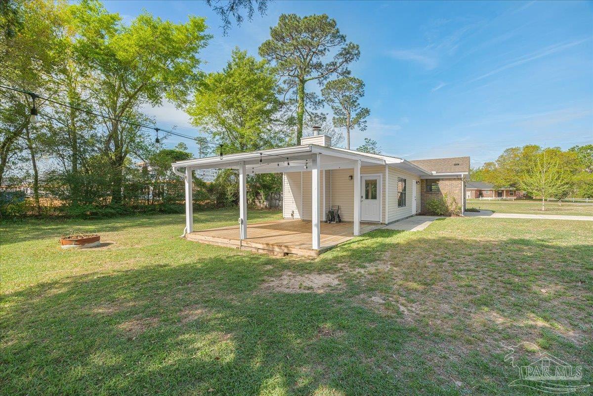 5946 Greenfield Street Pace, FL 32571 - Photo 15 of 42 a view of a house with backyard and sitting area