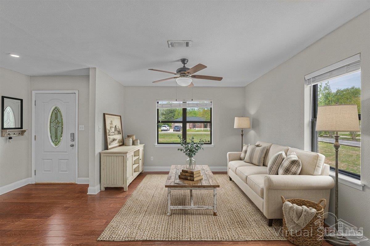 5946 Greenfield Street Pace, FL 32571 - Photo 18 of 42 a living room with furniture and a large window