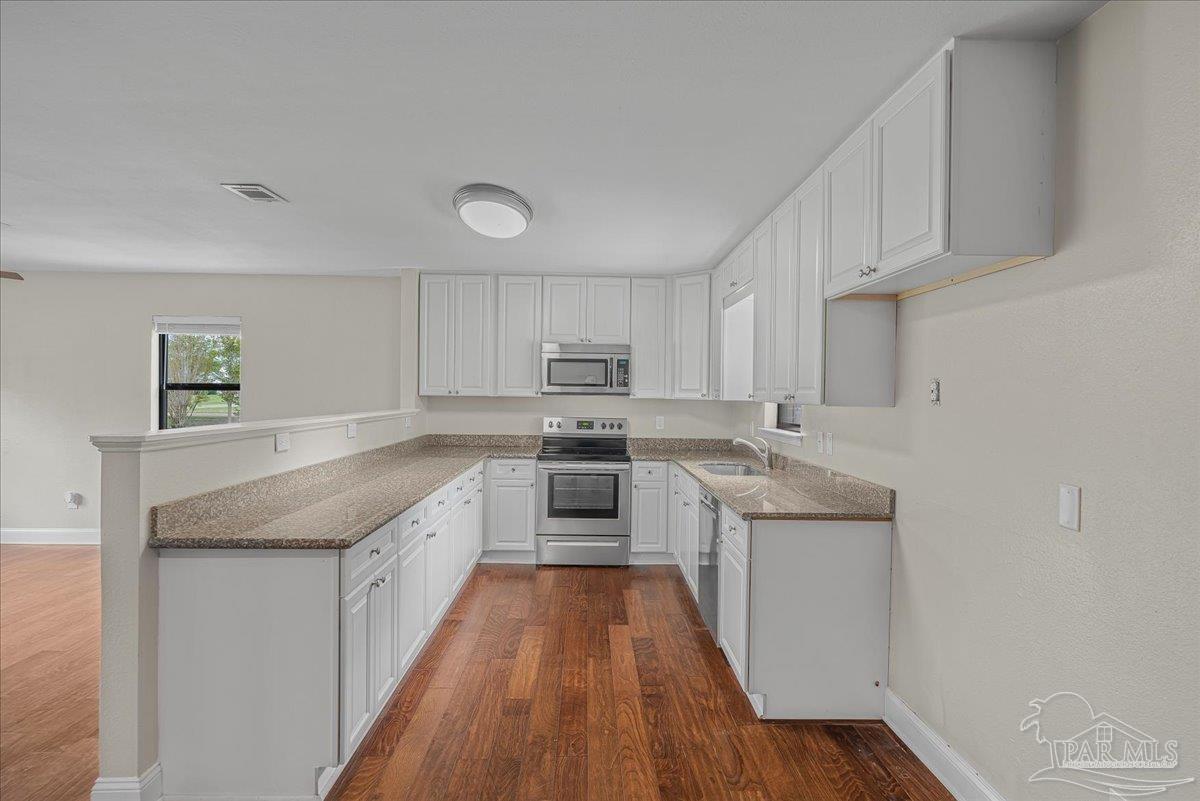 5946 Greenfield Street Pace, FL 32571 - Photo 20 of 42 a kitchen with granite countertop a sink and cabinets