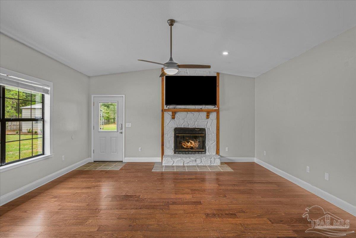 5946 Greenfield Street Pace, FL 32571 - Photo 24 of 42 a view of a room with window fireplace and windows