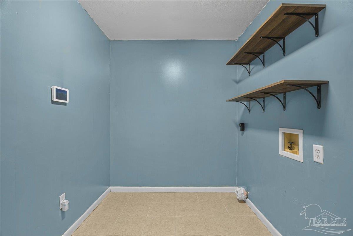 5946 Greenfield Street Pace, FL 32571 - Photo 28 of 42 a view of a room with a walk in closet