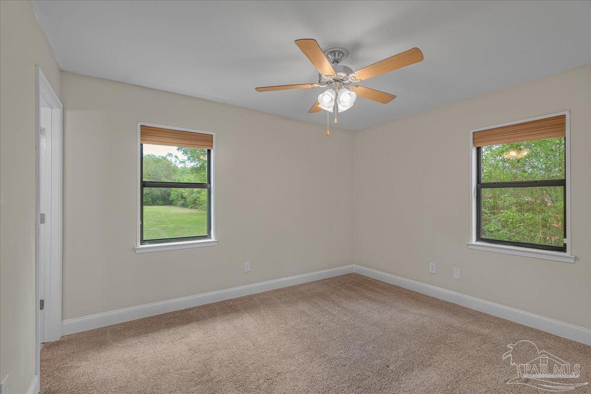 5946 Greenfield Street Pace, FL 32571 - Photo 32 of 42 an empty room with a window