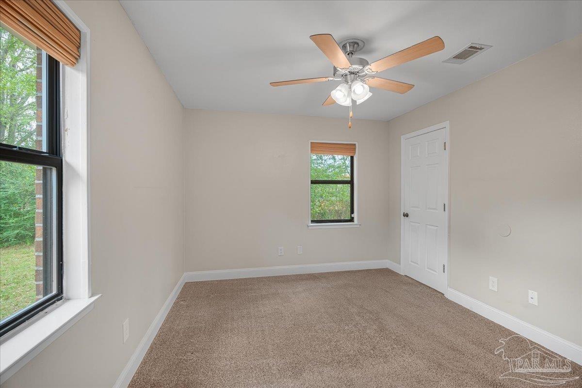 5946 Greenfield Street Pace, FL 32571 - Photo 33 of 42 an empty room with a ceiling fan and window