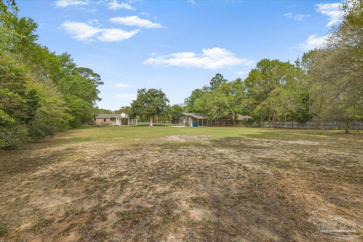 5946 Greenfield Street Pace, FL 32571 - Photo 38 of 42 a view of a field with trees in the background