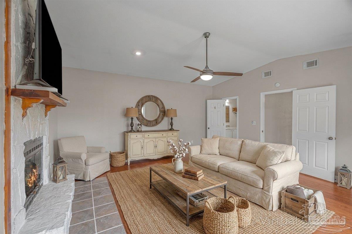 5946 Greenfield Street Pace, FL 32571 - Photo 4 of 42 a living room with furniture a rug and a chandelier