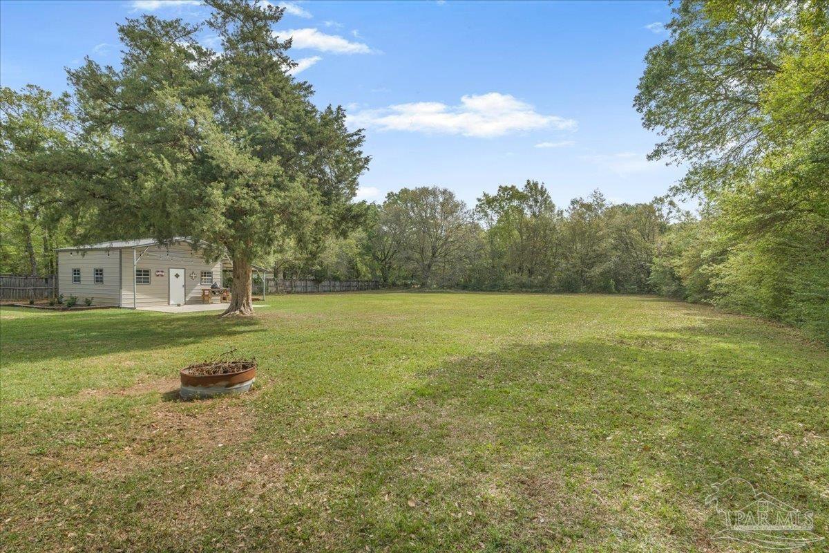 5946 Greenfield Street Pace, FL 32571 - Photo 6 of 42 a view of a house with a yard