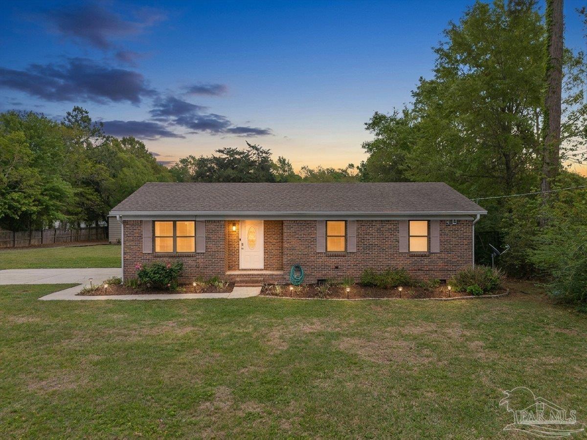 5946 Greenfield Street Pace, FL 32571 - Photo 8 of 42 a front view of a house with a yard