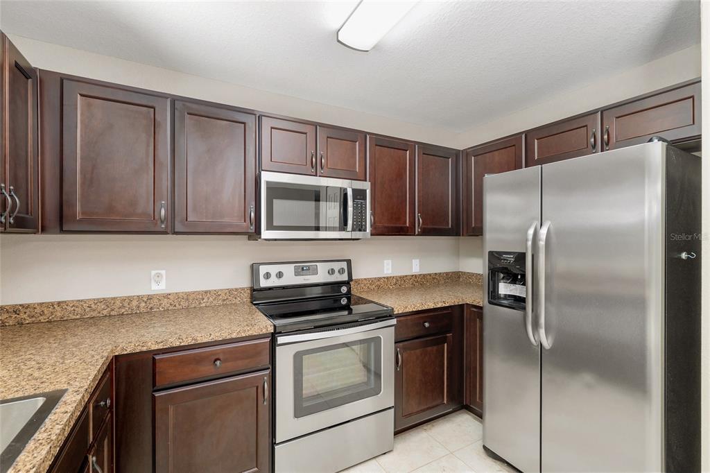 2 Hemlock Loop Drive Ocala, FL 34472 - Photo 11 of 28 a kitchen with a refrigerator stove and microwave