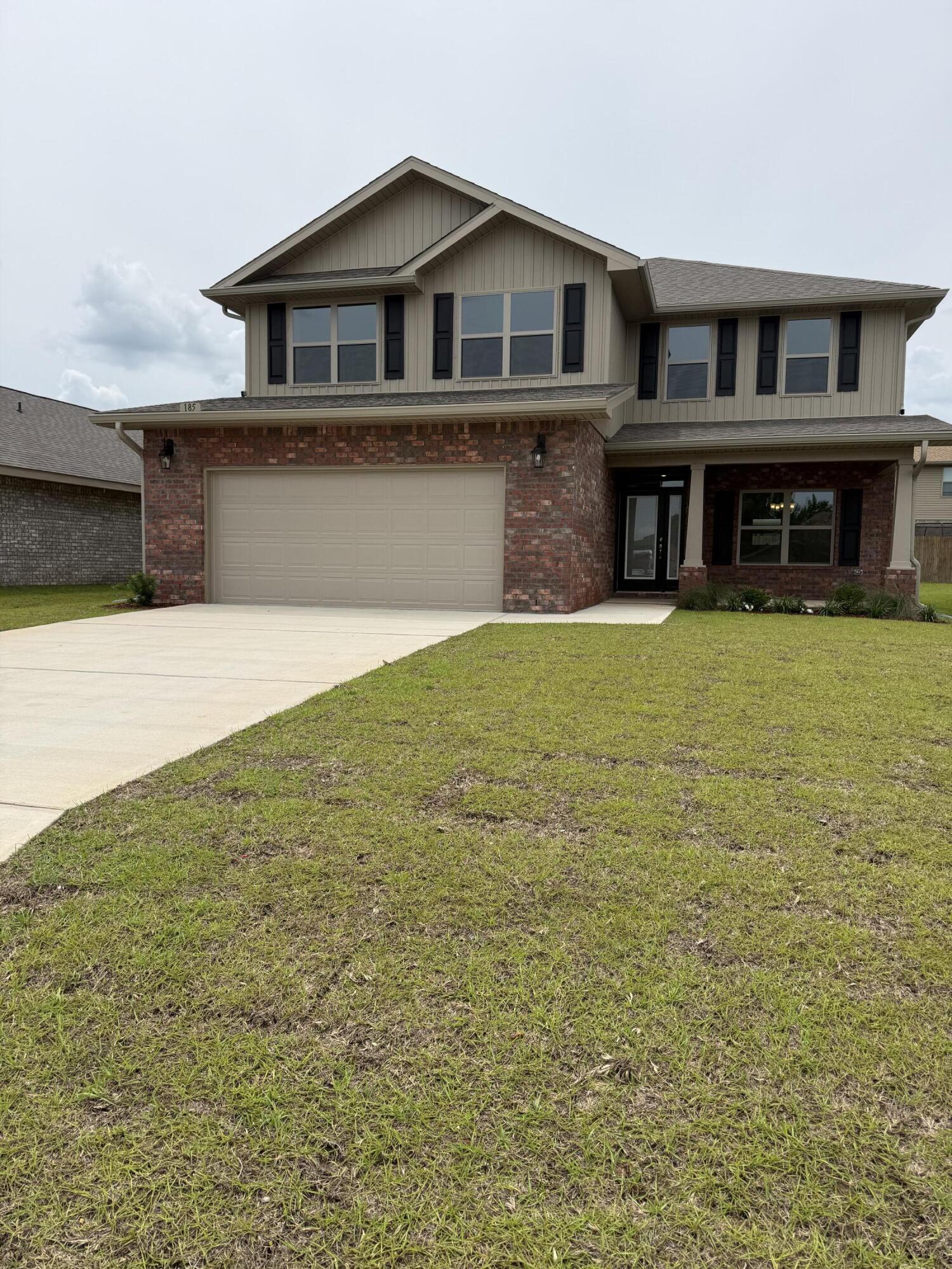 a front view of a house with yard and staircase