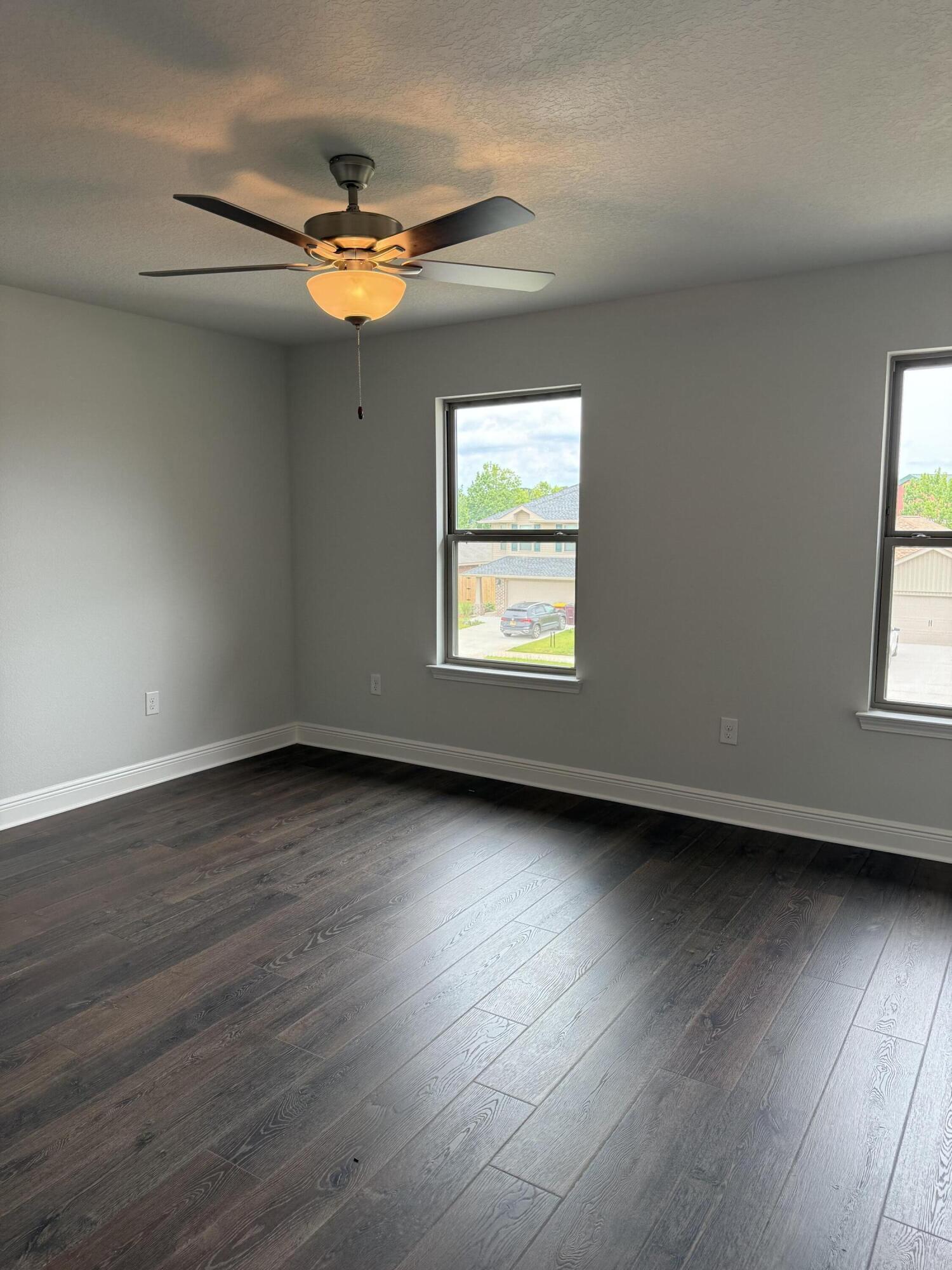185 Ridgeway Circle Crestview, FL 32536 - Photo 19 of 30 an empty room with wooden floor and windows