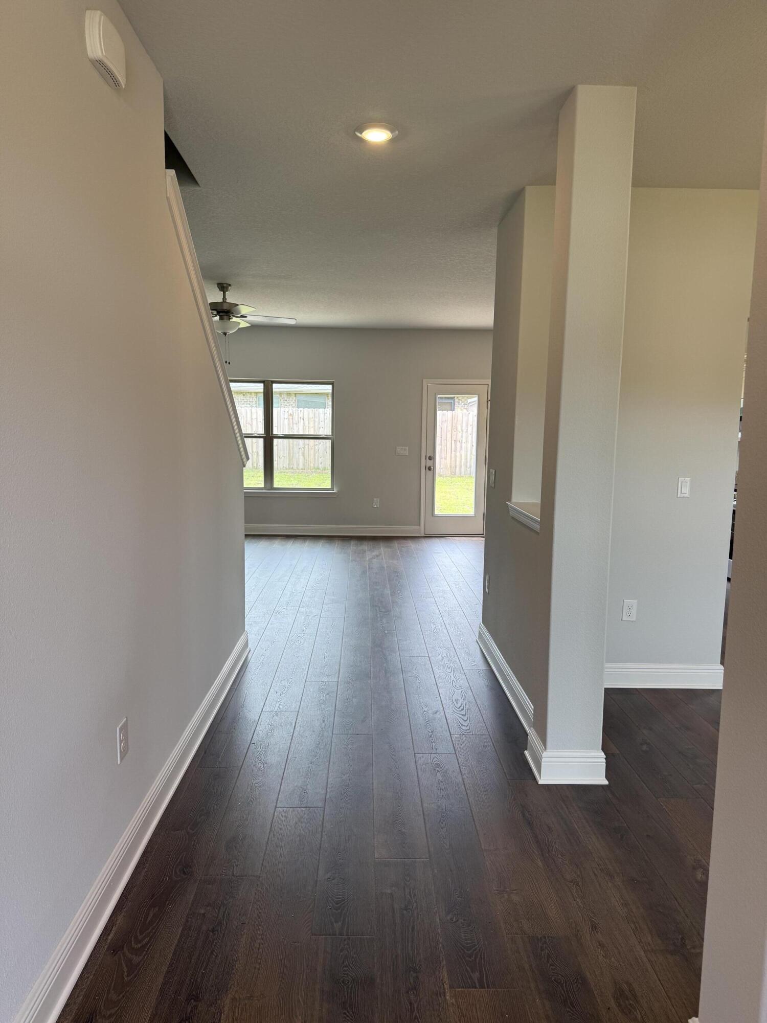 185 Ridgeway Circle Crestview, FL 32536 - Photo 4 of 30 wooden floor in an empty room with a window