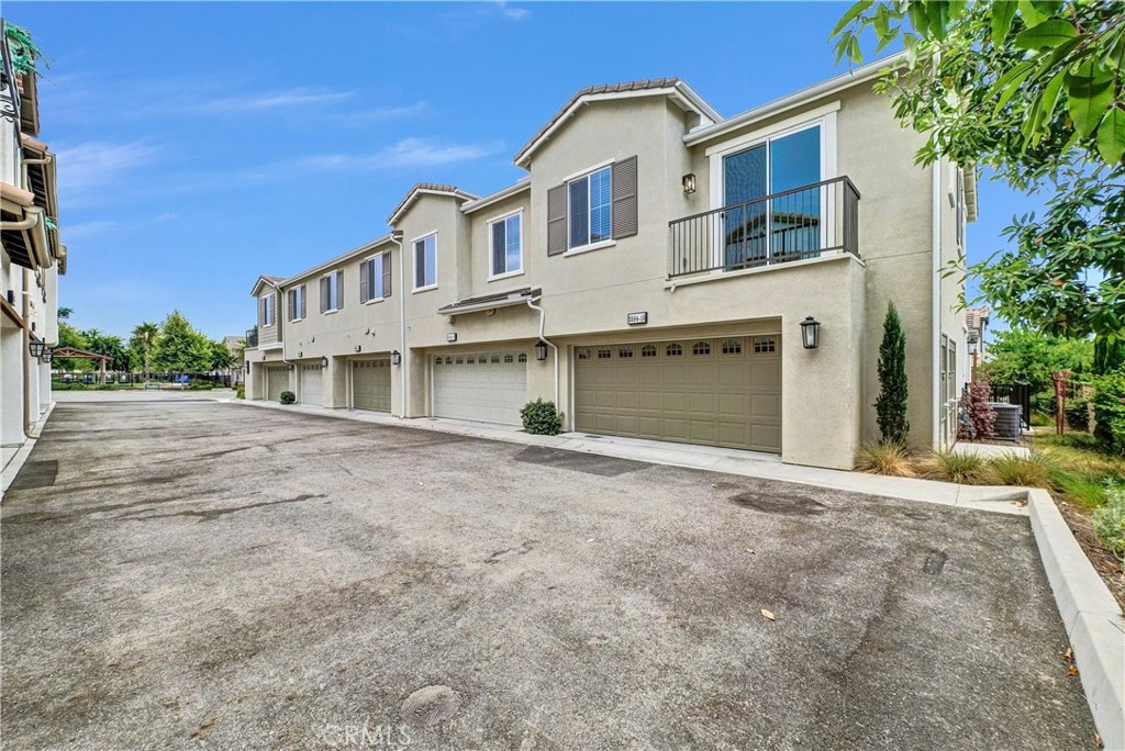 5584 Kate Way, Unit 10 Fontana, CA 92336 - Photo 29 of 42 a front view of a house with a yard