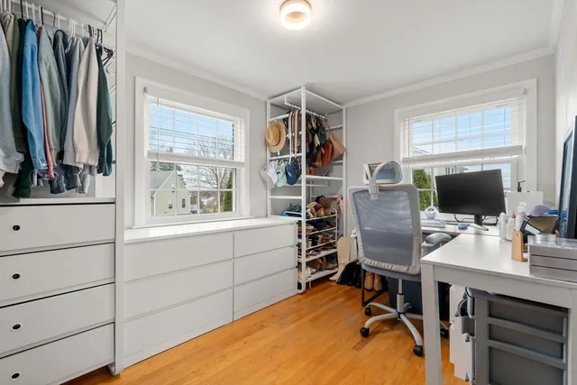 a view of a workspace with furniture and a window
