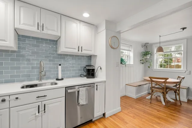 a kitchen with a sink cabinets and wooden floor