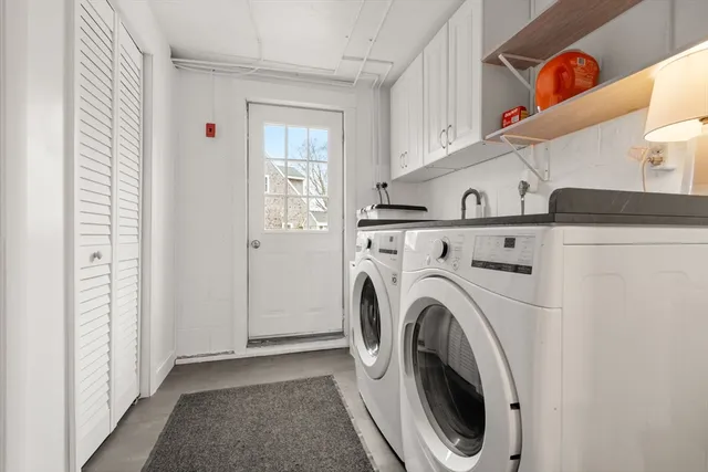 a view of a hallway with washer and dryer