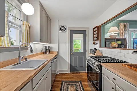 a kitchen that has a sink and a stove