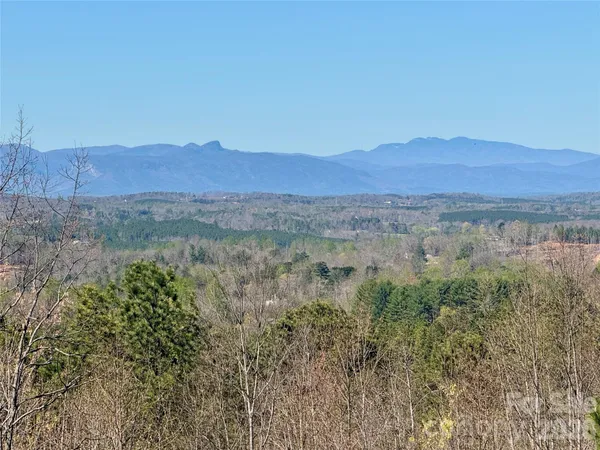 a view of mountain and a yard