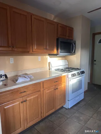 a kitchen with granite countertop cabinets and white appliances