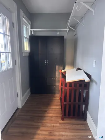 a view of a hallway with wooden floor and staircase