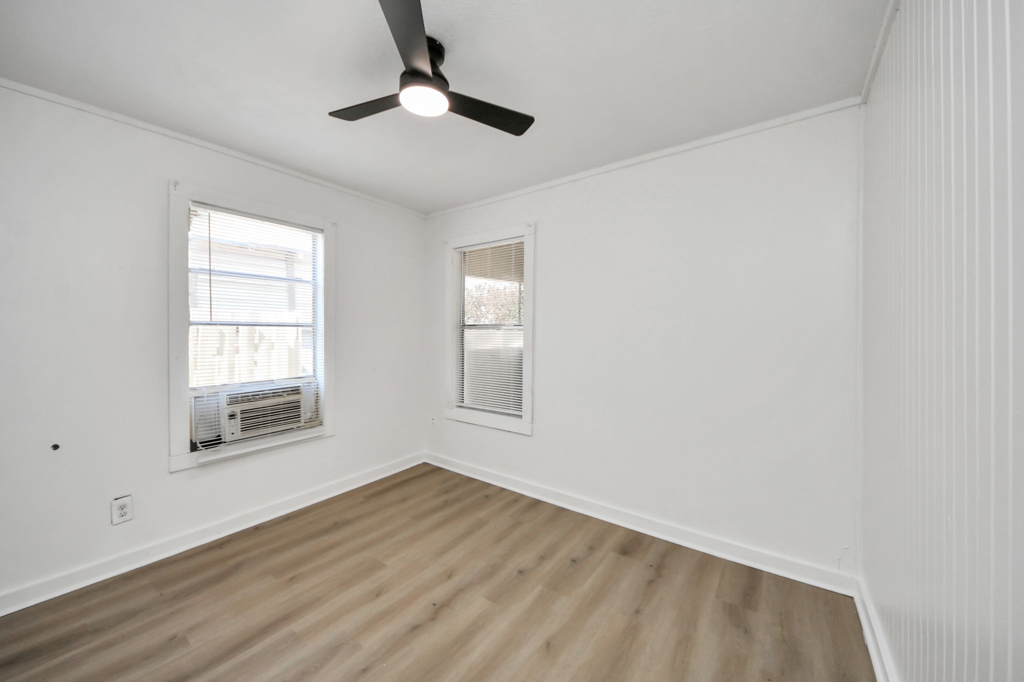 3804 Lila Street Houston, TX 77026 - Photo 11 of 16 wooden floor in an empty room with a window