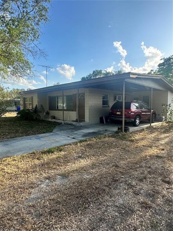 a couple of table and chairs in front of house