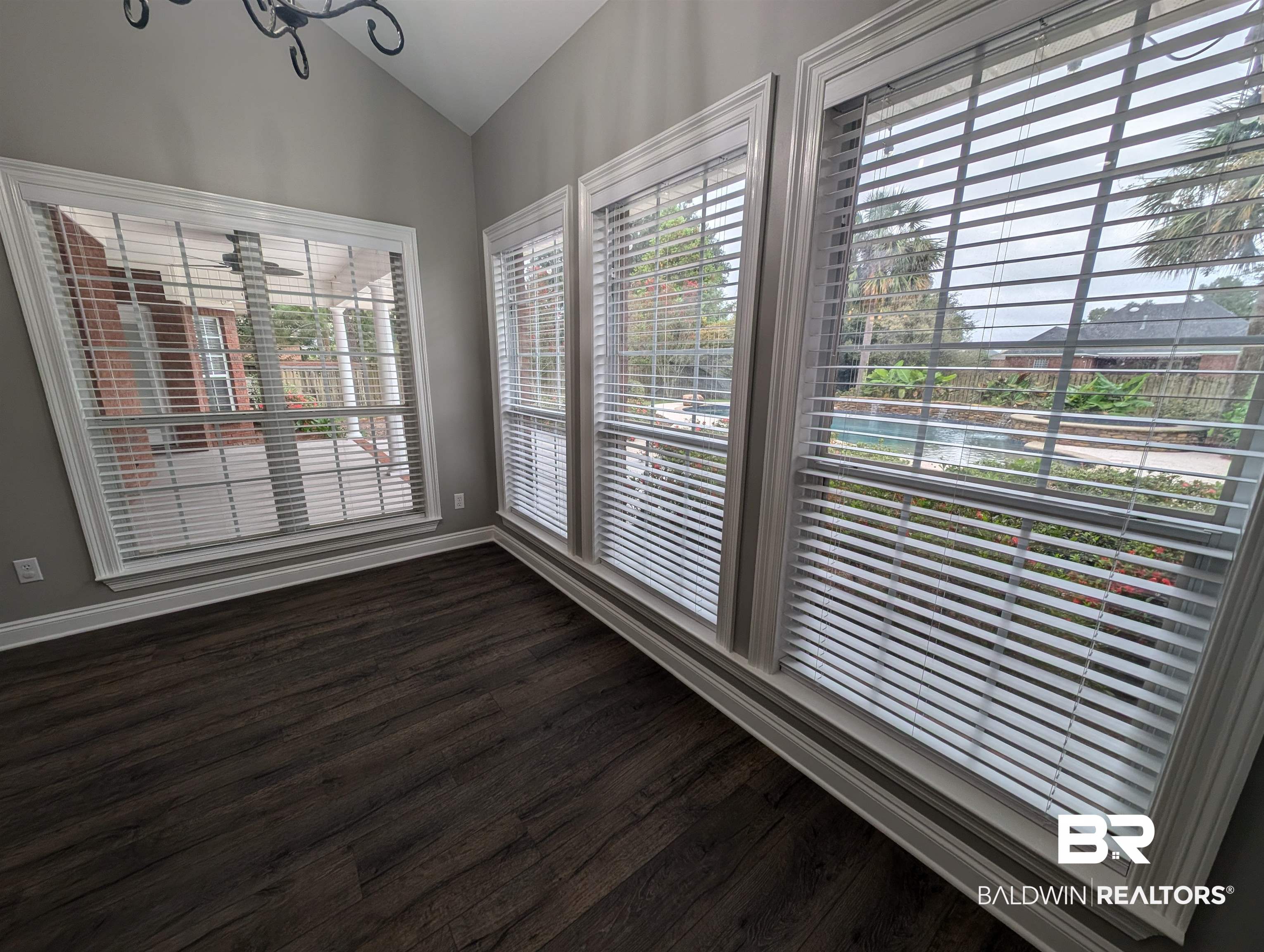 11623 Halcyon Loop Daphne, AL 36526 - Photo 20 of 90 Informal dining room for quick family meals featuring vaulted ceiling and wrap around windows overlooking the backyard with colorful flowers in bloom