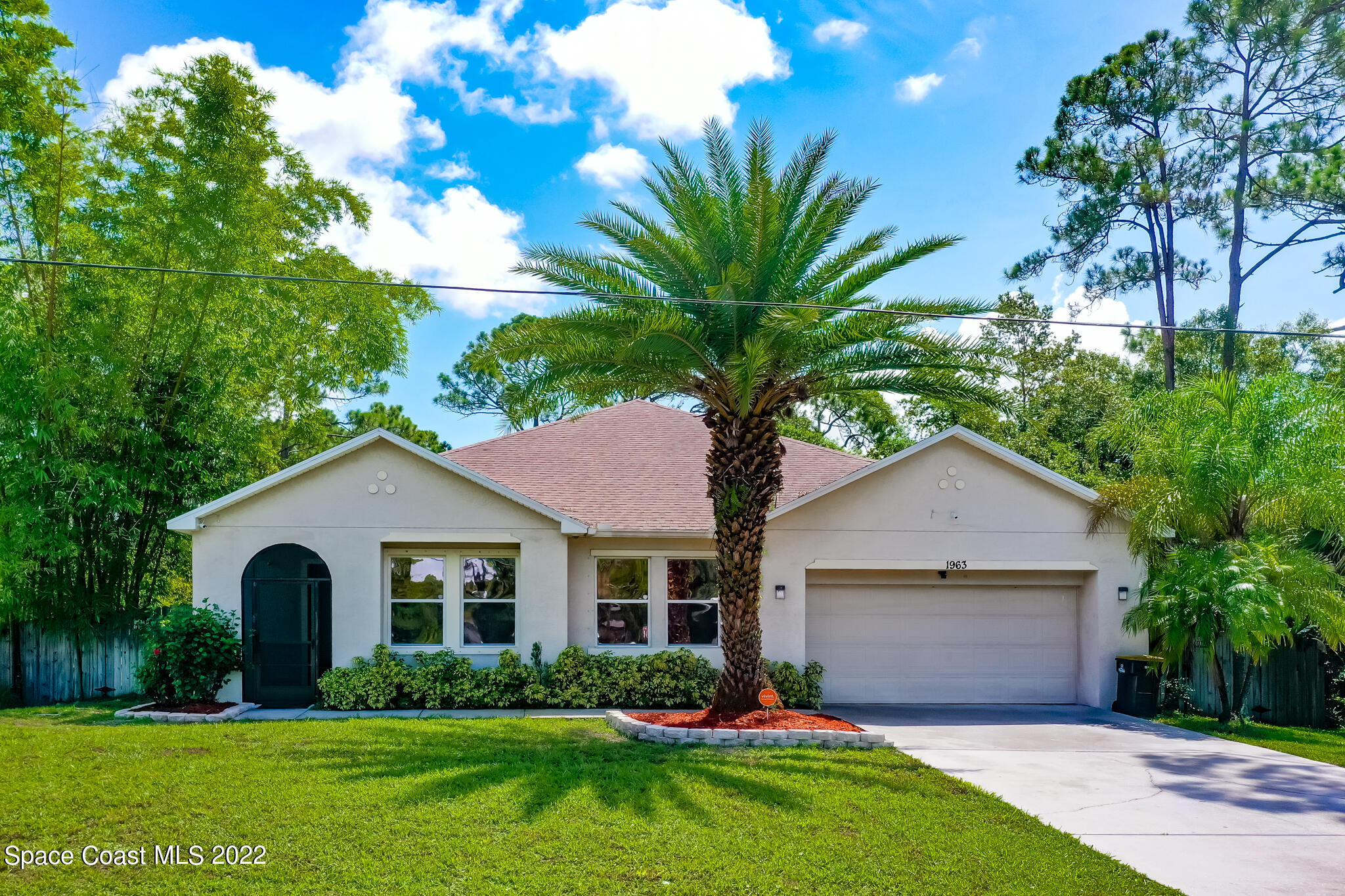 1963 Jupiter Boulevard Southwest Palm Bay, FL 32908 - Photo 1 of 42 a front view of house with yard and green space
