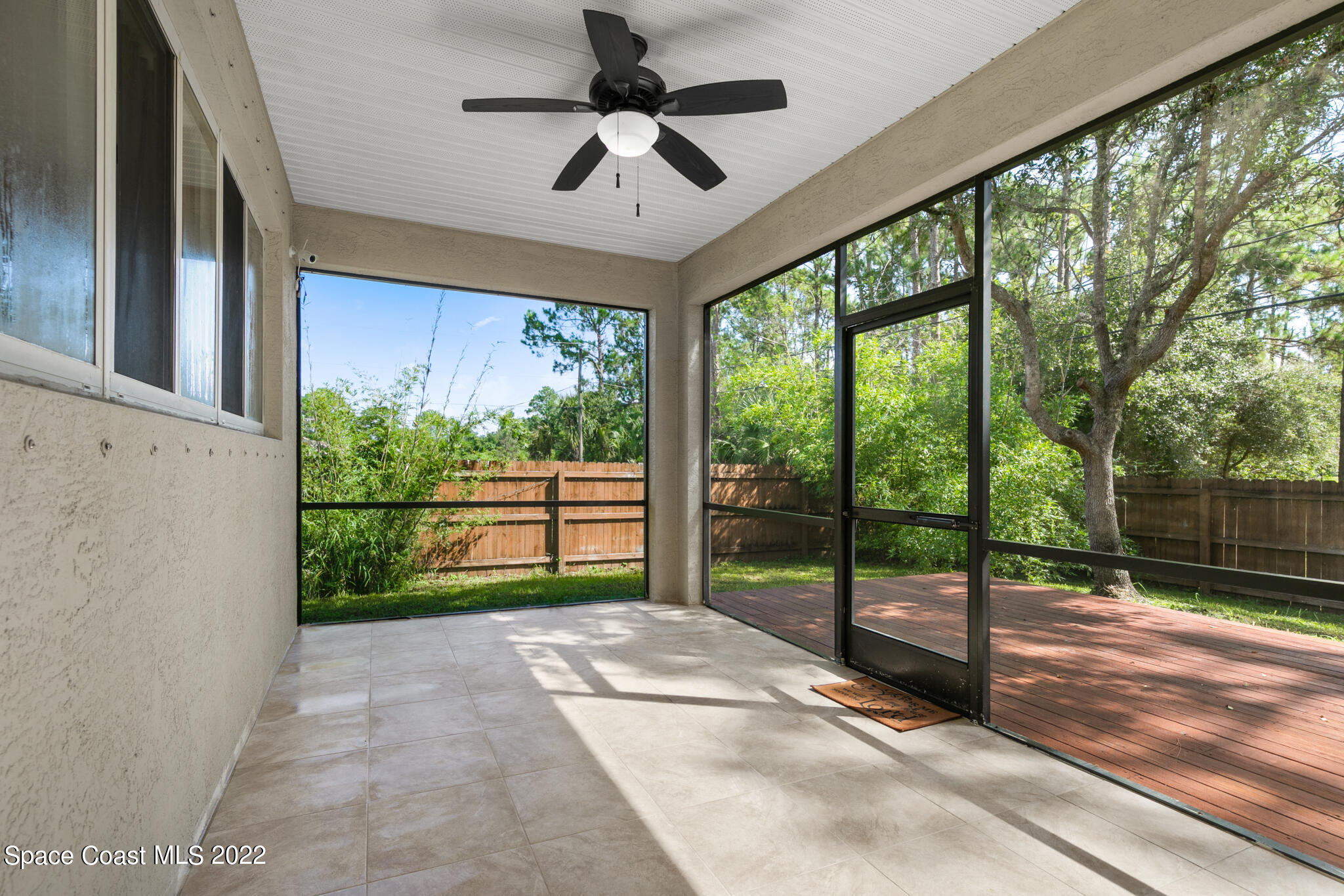 1963 Jupiter Boulevard Southwest Palm Bay, FL 32908 - Photo 18 of 42 a view of porch with a backyard of ceiling window