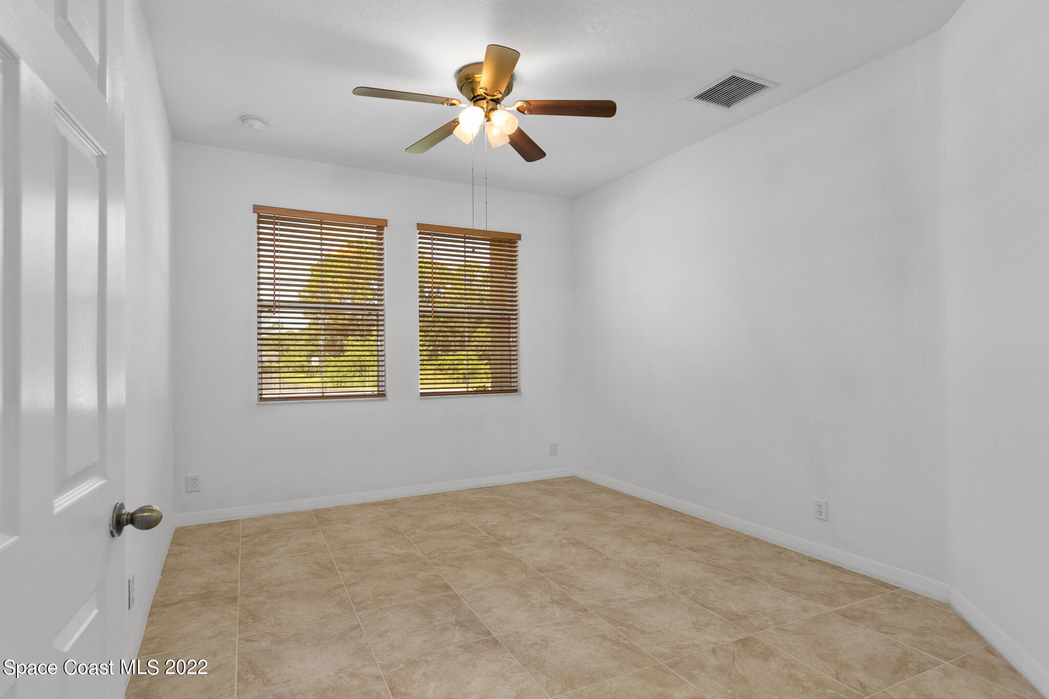 1963 Jupiter Boulevard Southwest Palm Bay, FL 32908 - Photo 20 of 42 an empty room with ceiling fan and window