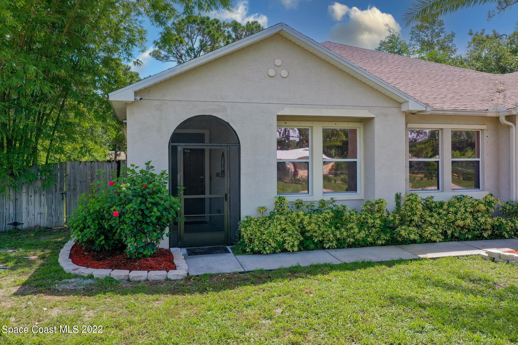 1963 Jupiter Boulevard Southwest Palm Bay, FL 32908 - Photo 2 of 42 a front view of a house with a yard