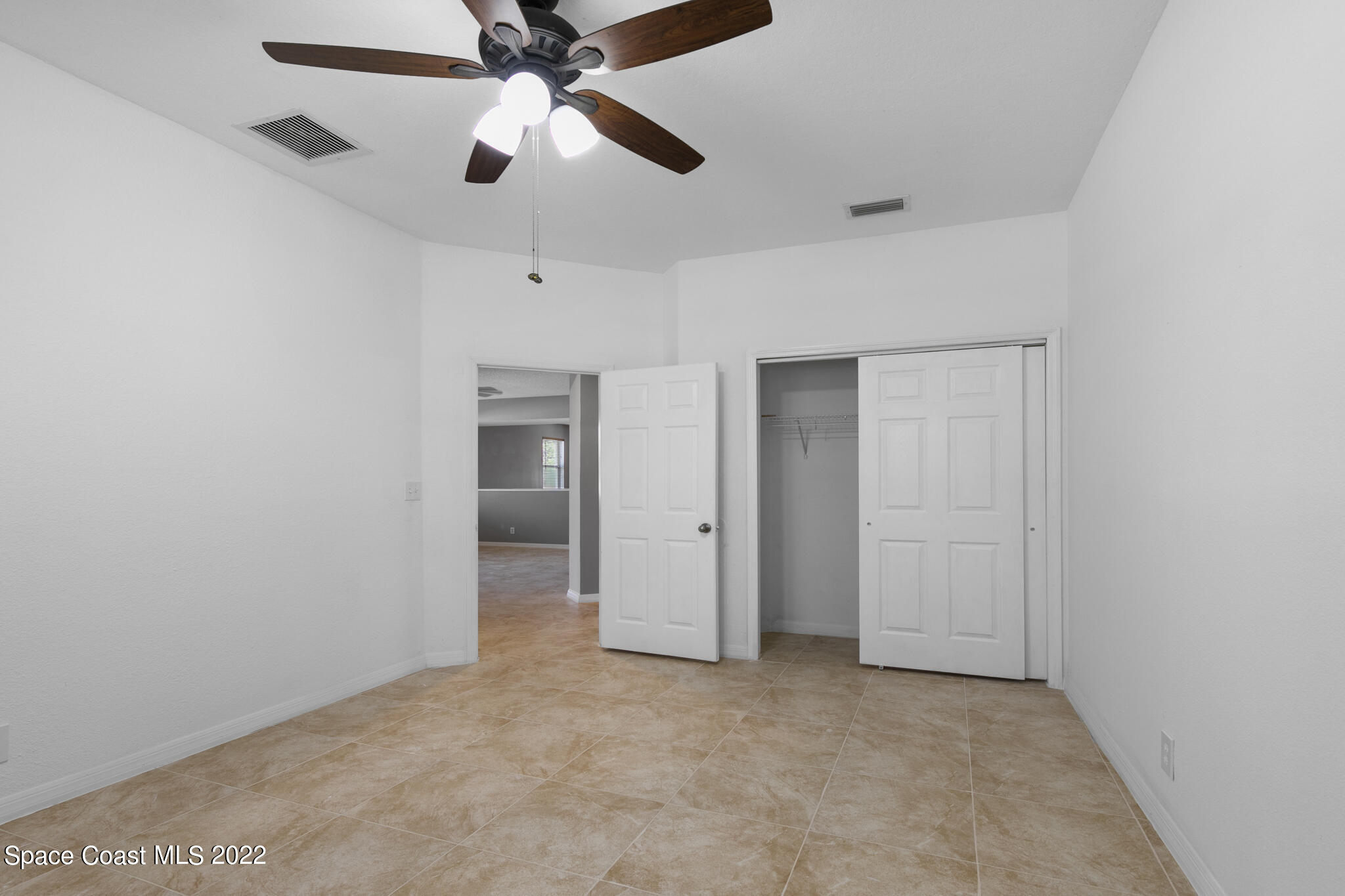 1963 Jupiter Boulevard Southwest Palm Bay, FL 32908 - Photo 22 of 42 an empty room with chandelier fan