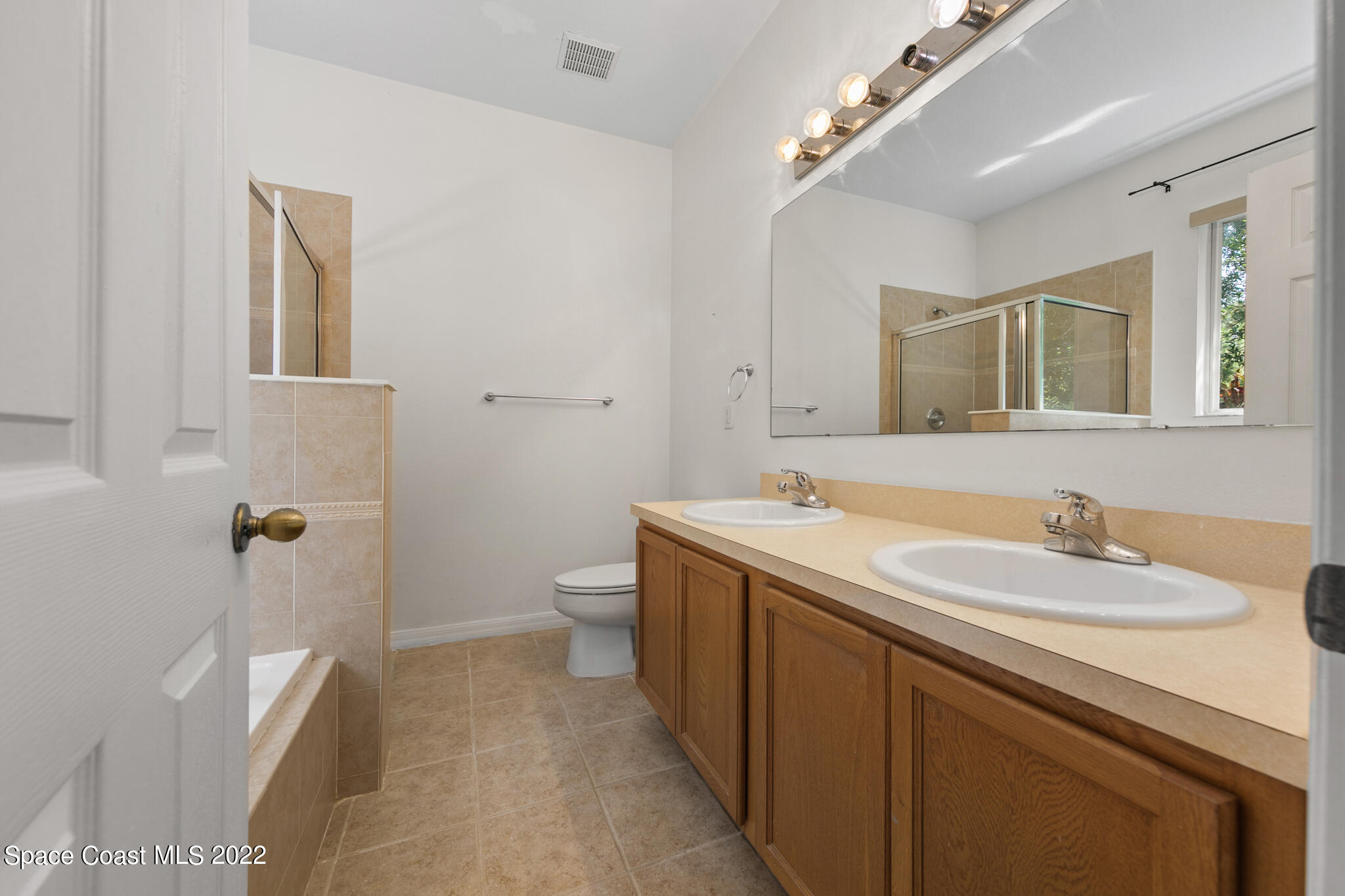 1963 Jupiter Boulevard Southwest Palm Bay, FL 32908 - Photo 30 of 42 a bathroom with a sink and mirror