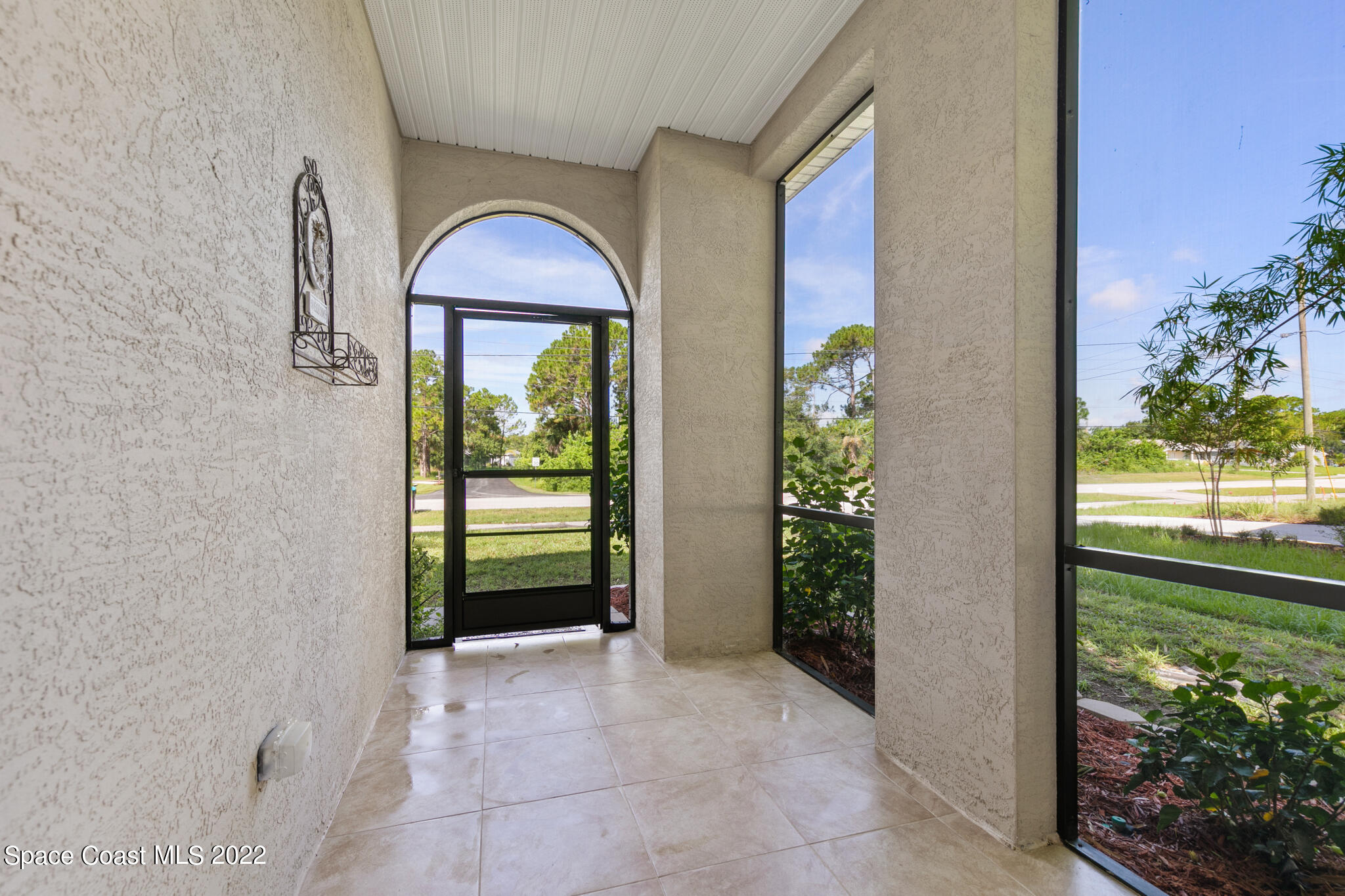 1963 Jupiter Boulevard Southwest Palm Bay, FL 32908 - Photo 3 of 42 a view of entryway with garden