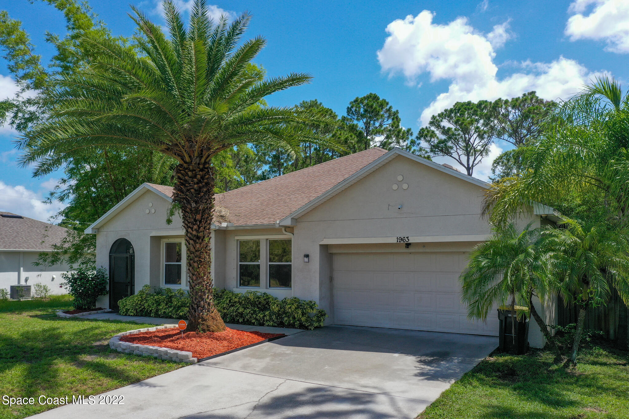 1963 Jupiter Boulevard Southwest Palm Bay, FL 32908 - Photo 35 of 42 a front view of house with yard and green space