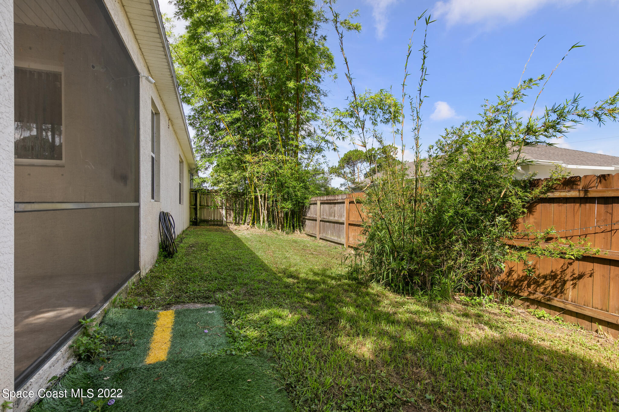 1963 Jupiter Boulevard Southwest Palm Bay, FL 32908 - Photo 36 of 42 a backyard of a house with lots of green space