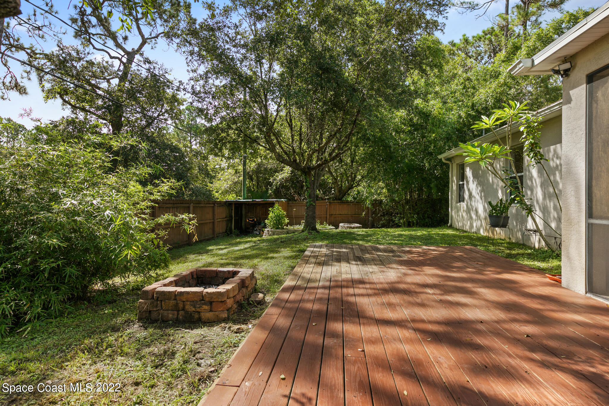 1963 Jupiter Boulevard Southwest Palm Bay, FL 32908 - Photo 39 of 42 a view of a backyard with large trees