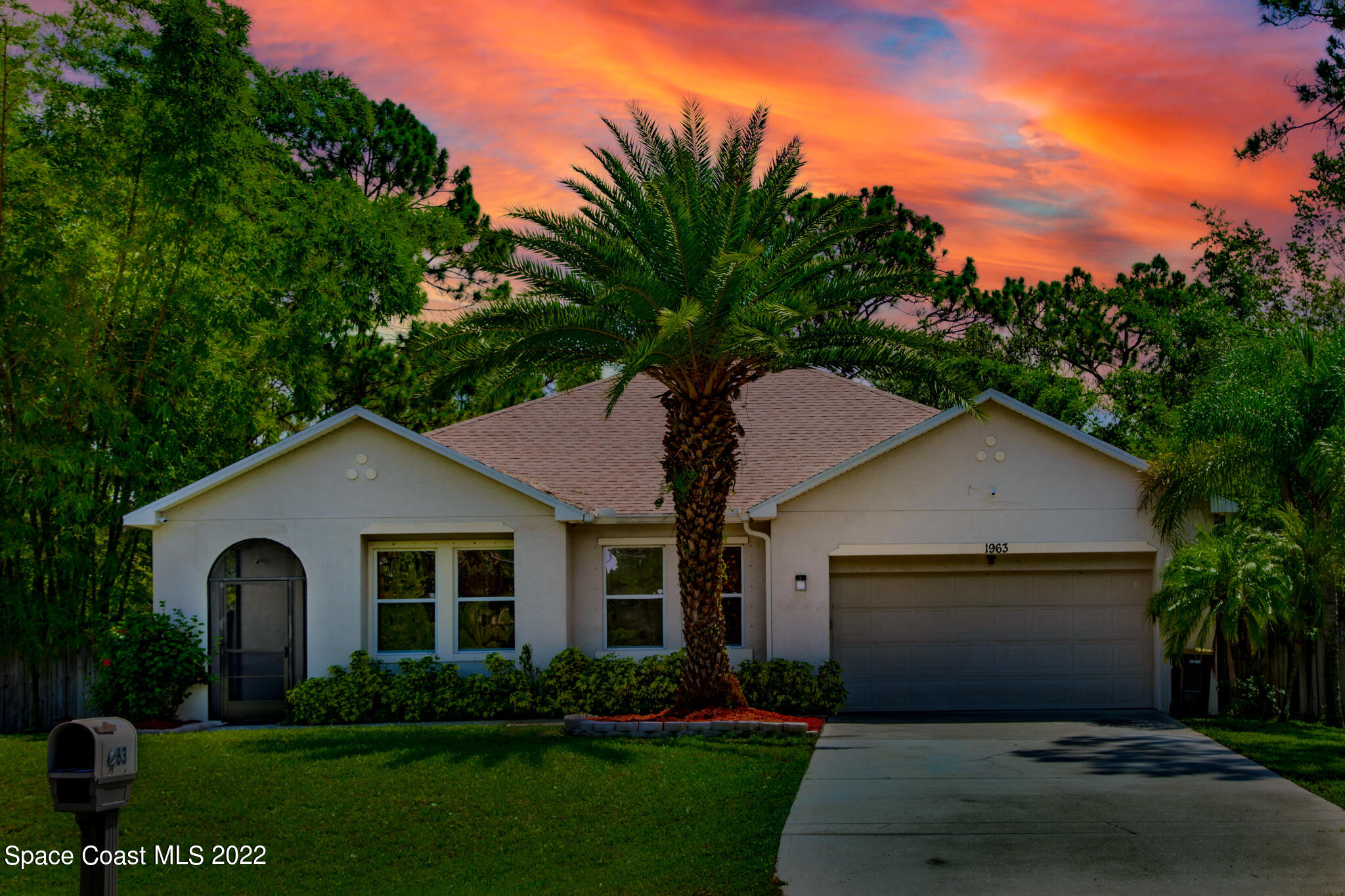1963 Jupiter Boulevard Southwest Palm Bay, FL 32908 - Photo 42 of 42 a front view of a house with a garden and plants