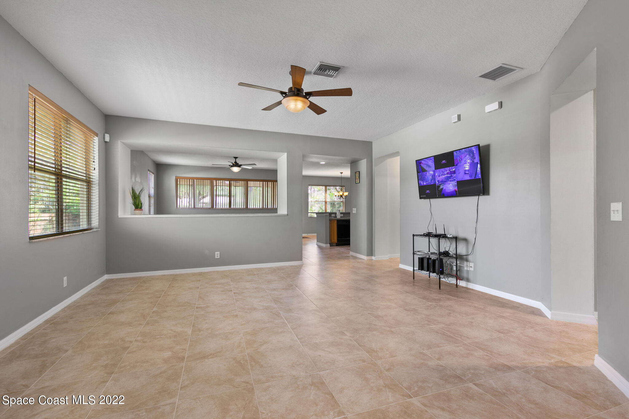 1963 Jupiter Boulevard Southwest Palm Bay, FL 32908 - Photo 6 of 42 a view of livingroom with furniture chandelier and windows