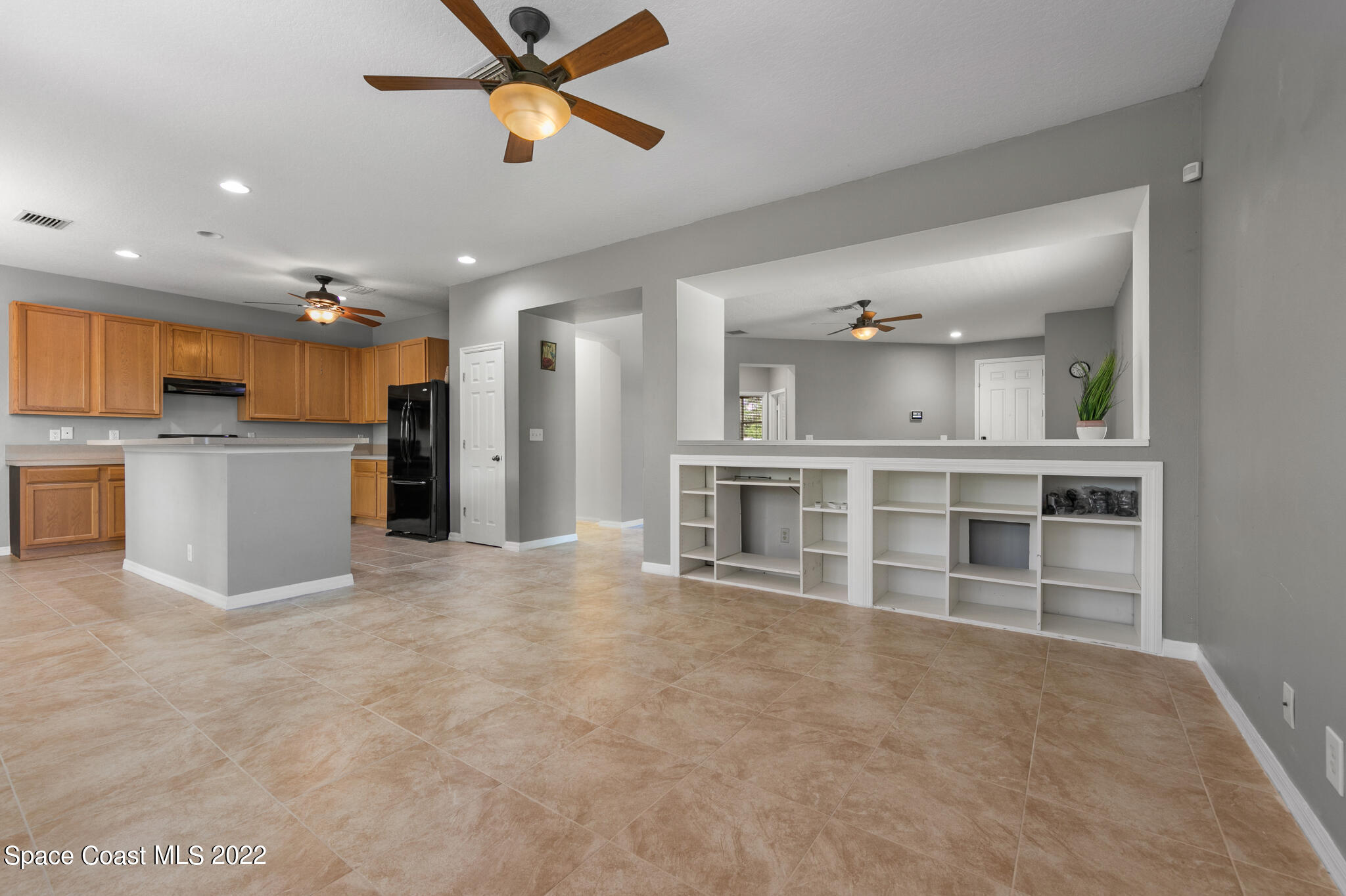 1963 Jupiter Boulevard Southwest Palm Bay, FL 32908 - Photo 9 of 42 a view of a kitchen with a sink and a refrigerator