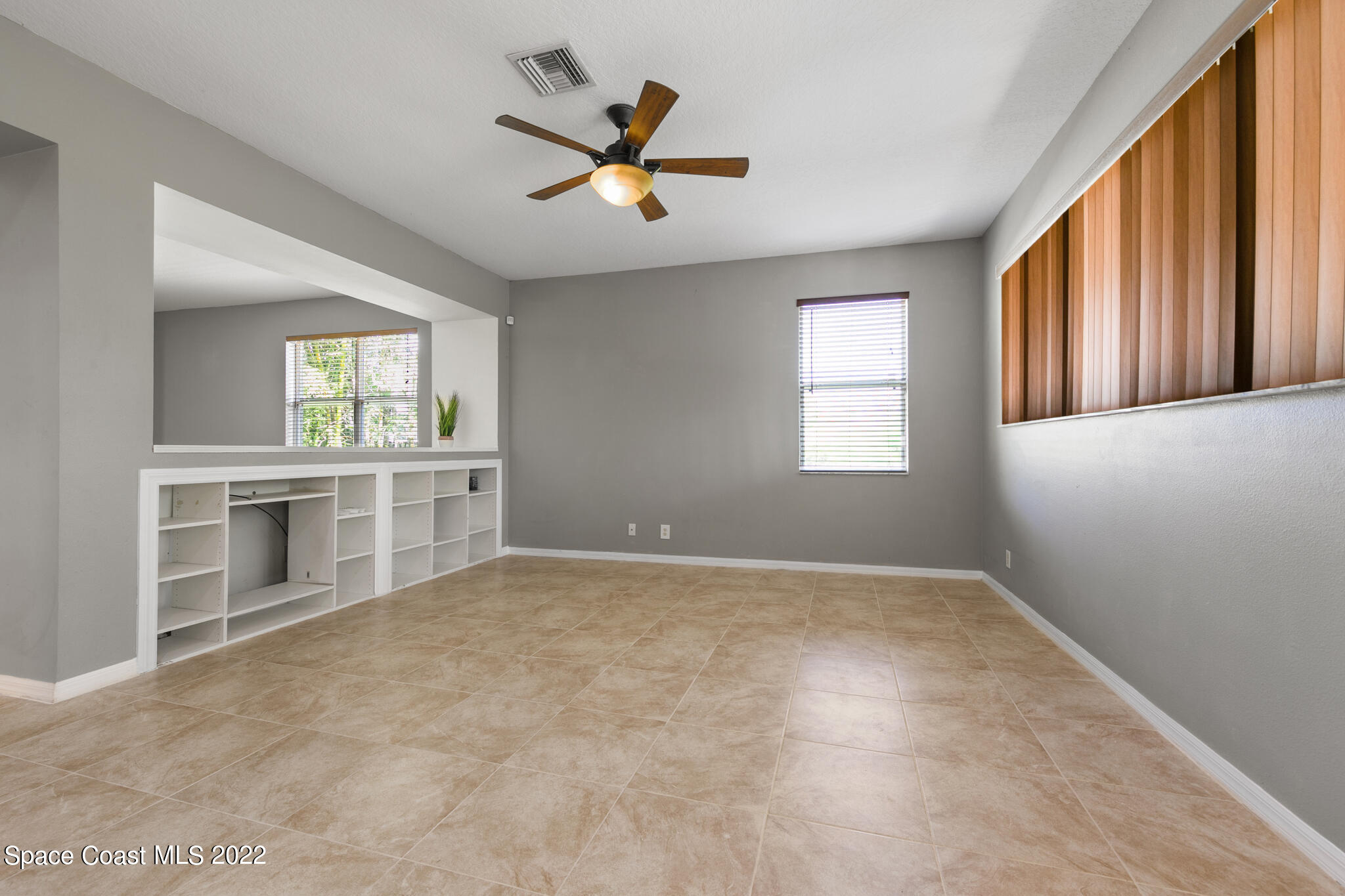 1963 Jupiter Boulevard Southwest Palm Bay, FL 32908 - Photo 10 of 42 a view of a livingroom with a ceiling fan and window