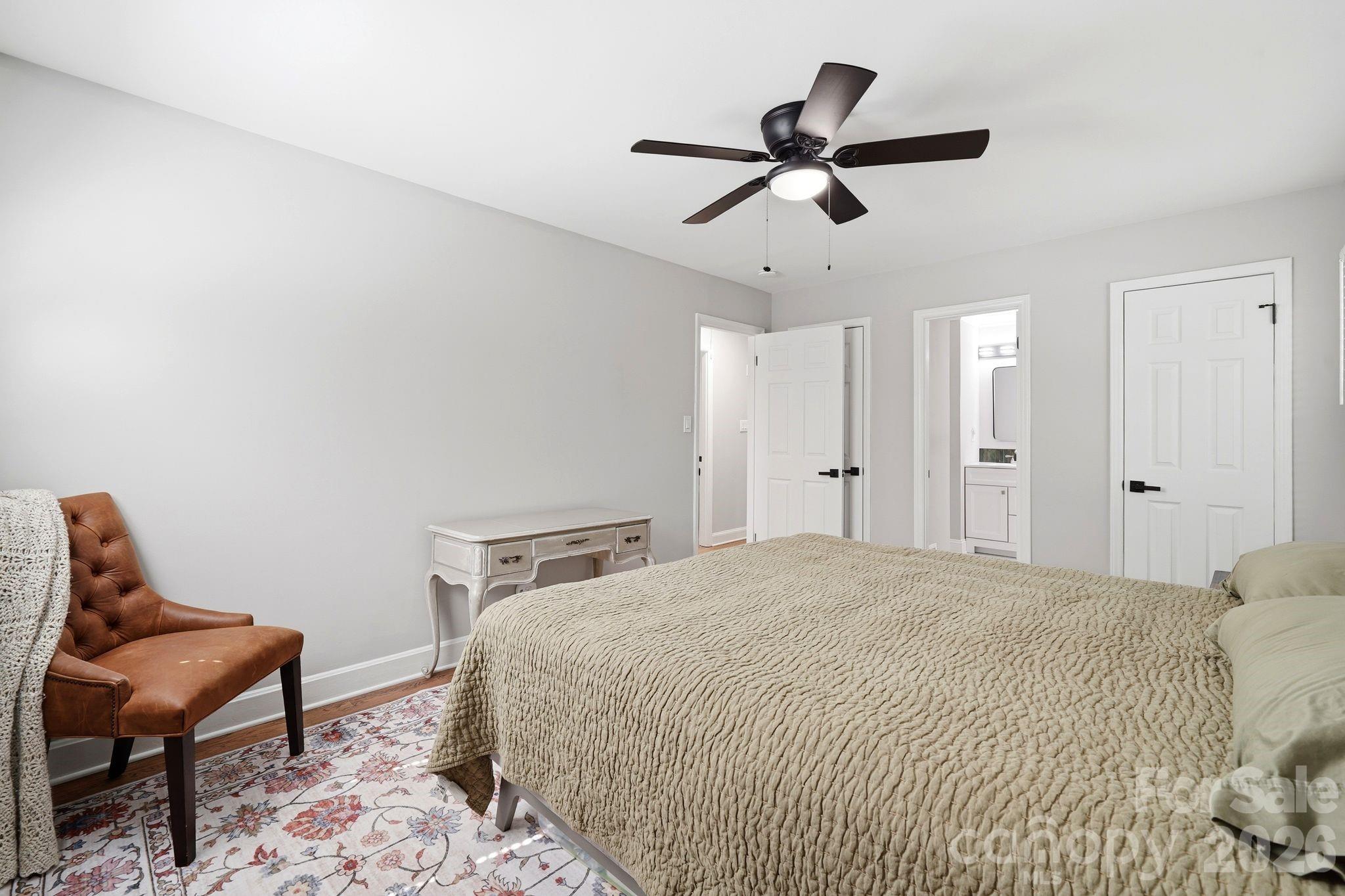 7552 Idlewild Road Charlotte, NC 28212 - Photo 10 of 40 a bedroom with a bed a chair and potted plant