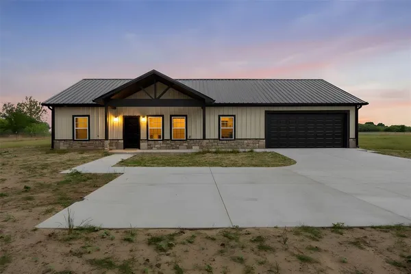 a front view of a house with yard