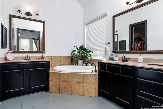 a bathroom with a sink vanity and mirror