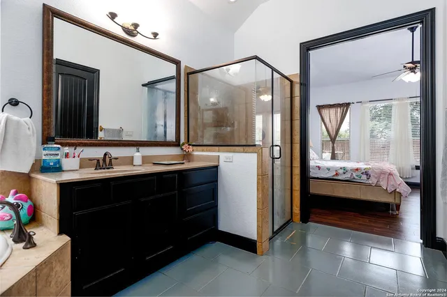 a en suite bathroom with a sink and a mirror